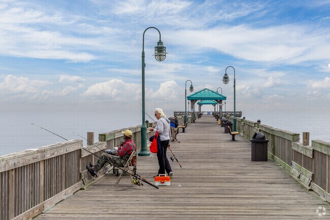 A man and woman fishing from Fox Hill Pier